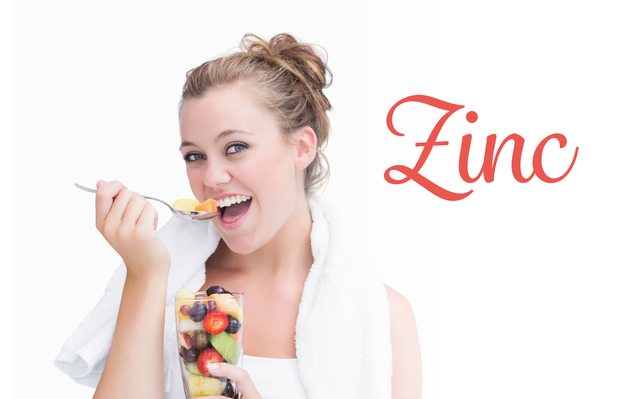 The word zinc against woman eating fruit and smiling